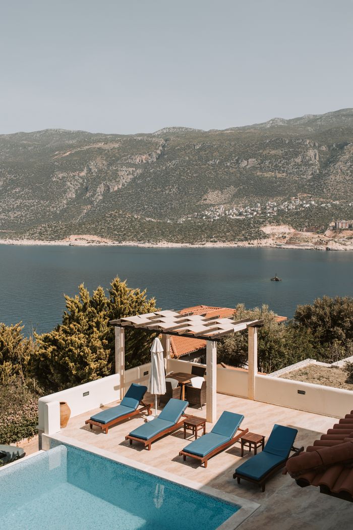 our-story-01 Stunning poolside view from a luxurious villa in Antalya, Turkey, over blue waters.